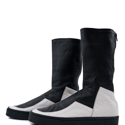 LOCO ONE ACHROMATIC COLLECTION. BOOTS EQUILIBRIUM. These are hand made Boots of Genuine Leather. The base of the boot is made of white Cow leather and the upper part and lining is made of black Lamb leather, with a black zipper on the back from mid ankle to top. The soles are made of black rubber glued and stitched. These have an Androgynous Style.