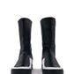 LOCO ONE ACHROMATIC COLLECTION.  BOOTS EQUILIBRIUM.  These are hand made Boots of Genuine Leather. The base of the boot is made of white Cow leather and the upper part and lining is made of black Lamb leather, with a black zipper on the back from mid ankle to top. The soles are made of black rubber glued and stitched. These have an Androgynous Style.