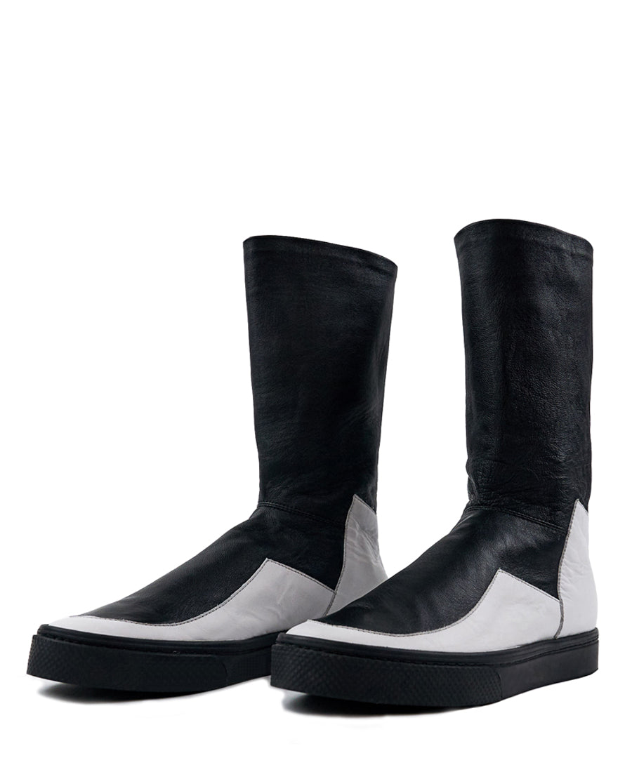 LOCO ONE ACHROMATIC COLLECTION.  BOOTS EQUILIBRIUM.  These are hand made Boots of Genuine Leather. The base of the boot is made of white Cow leather and the upper part and lining is made of black Lamb leather, with a black zipper on the back from mid ankle to top. The soles are made of black rubber glued and stitched. These have an Androgynous Style.