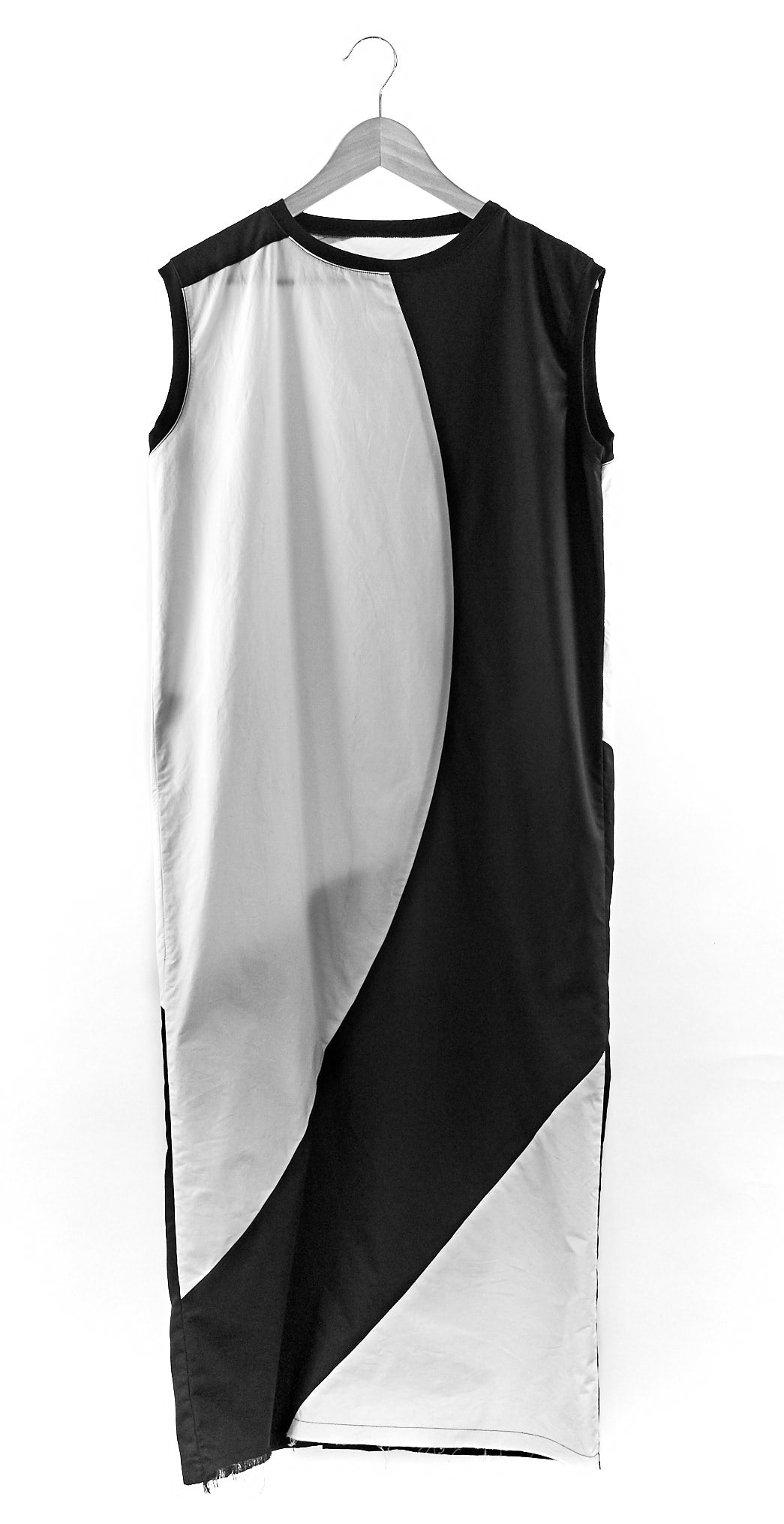 LOCO ONE ACHROMATIC COLLECTION.  DESIGN NUMERO 02.  Unisex dress made with natural materials only. Main composition is COTTON with neckline and sleeves details made of BAMBOO. Asymmetrical cuts, Futuristic look. Raw finishes on the front hem and a split in the back with a detailed, finished hem. Loose fit.